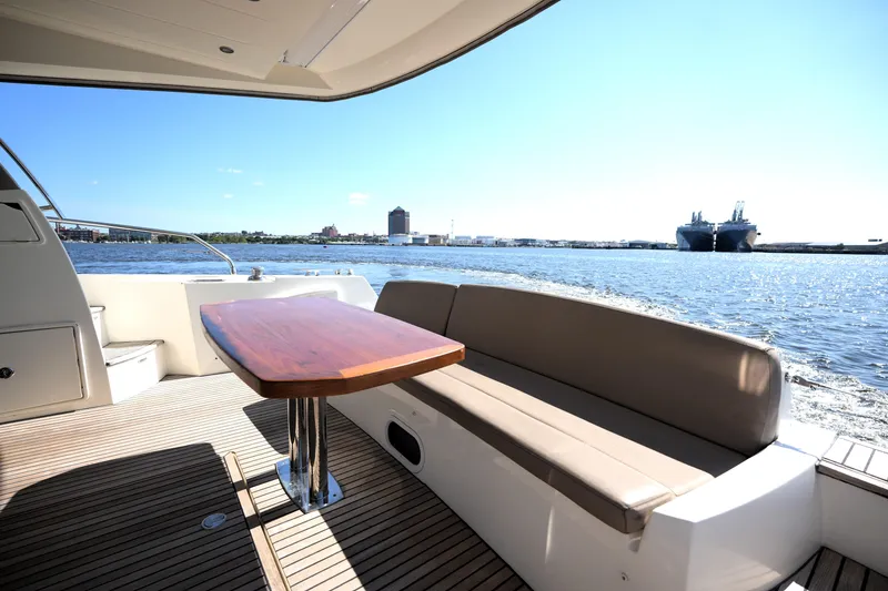 Slide: The Image of Luxury yacht deck with seating and table, Prestige 500, 2013 model, overlooking serene waters. - 21