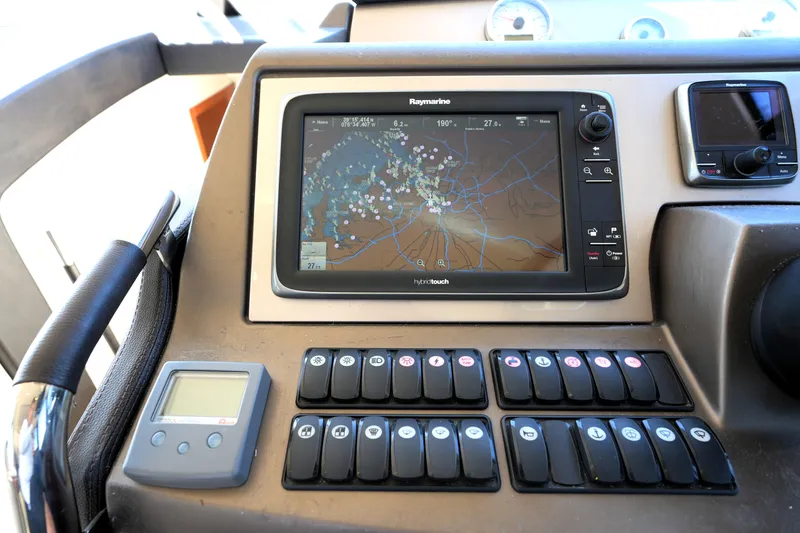 Slide: The Image of Control panel of a 2013 Prestige 500 yacht featuring a Raymarine navigation system. - 63