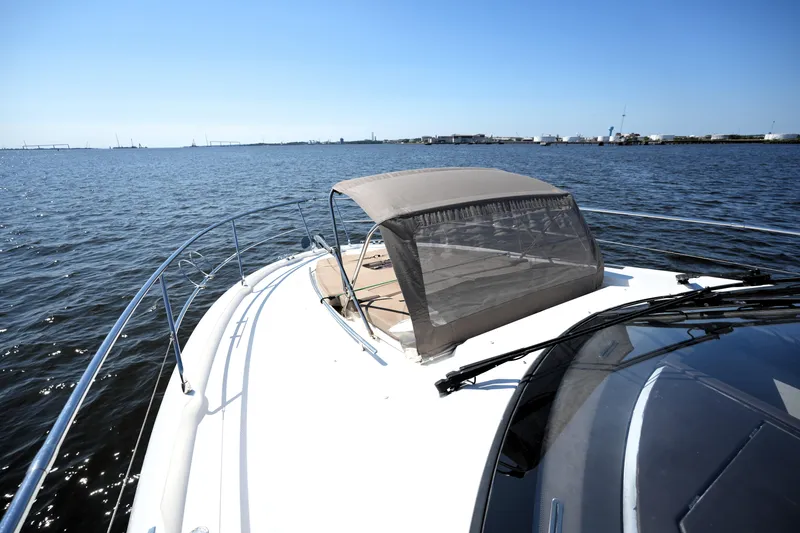Slide: The Image of 2013 Prestige 500 yacht cruising on open water under clear blue skies. - 36