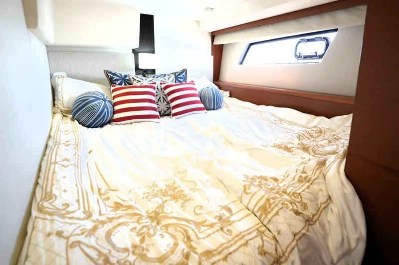 Slide: The Image of Luxurious bedroom interior on a 2013 Prestige 500 yacht with elegant bedding and decorative pillows. - 75
