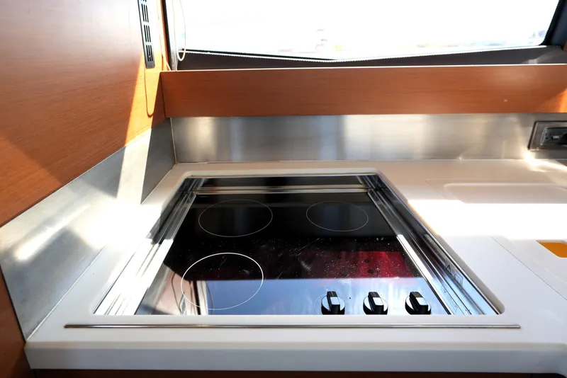 Slide: The Image of Modern kitchen stove in a 2013 Prestige 500 yacht, featuring sleek design and controls. - 51