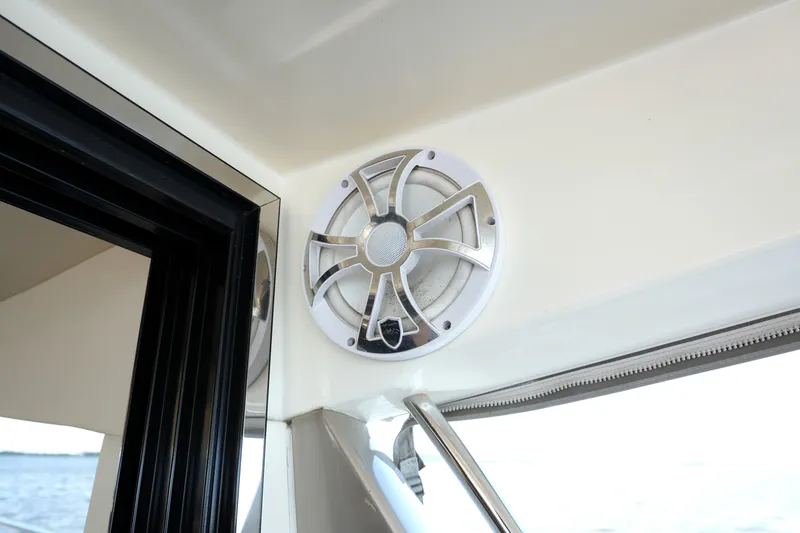 Slide: The Image of Speaker installed on a 2013 Prestige 500 yacht, near a window overlooking the sea. - 44
