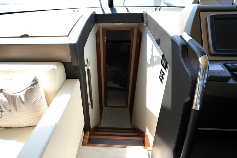 Slide: The Image of Interior view of a 2013 Prestige 500 yacht, featuring a stairway and modern design elements. - 67