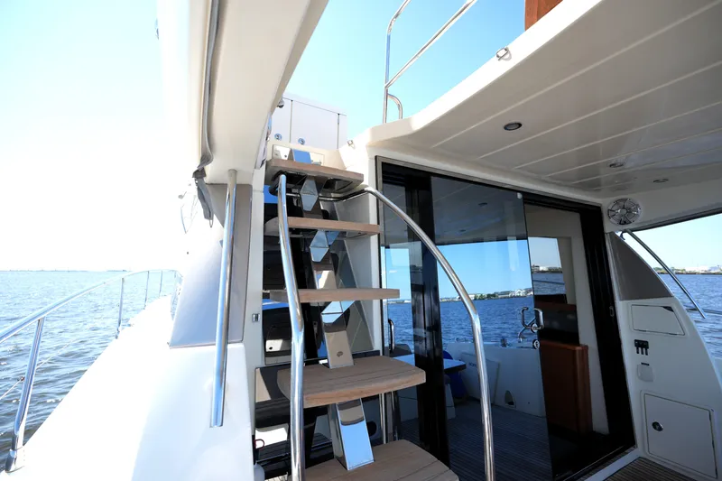 Slide: The Image of Prestige 500 yacht, 2013 model, featuring sleek stairs and modern interior with ocean view. - 25