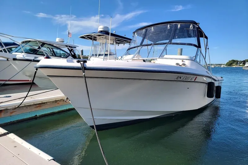 Slide: The Image of 2008 Grady-White Tournament 225 boat docked in a marina under clear blue skies. - 20