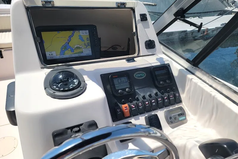 Slide: The Image of Dashboard of a 2008 Grady-White Tournament 225 boat with navigation equipment. - 3