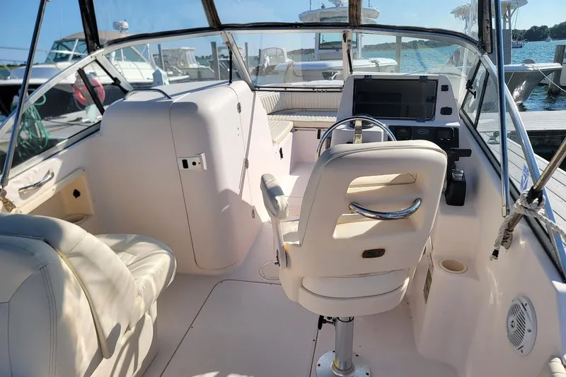 Slide: The Image of 2008 Grady-White Tournament 225 boat interior with helm, seating, and dashboard at marina. - 17