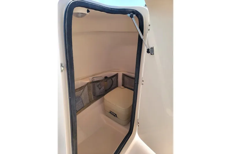 Slide: The Image of 2008 Grady-White Tournament 225 boat interior storage compartment with portable toilet. - 9
