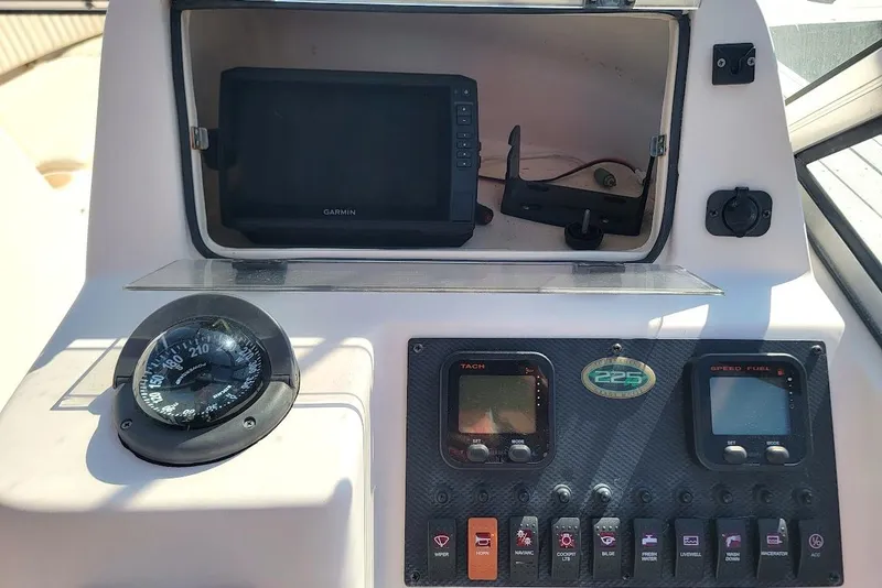 Slide: The Image of Dashboard of a 2008 Grady-White Tournament 225 boat with Garmin GPS and controls. - 3