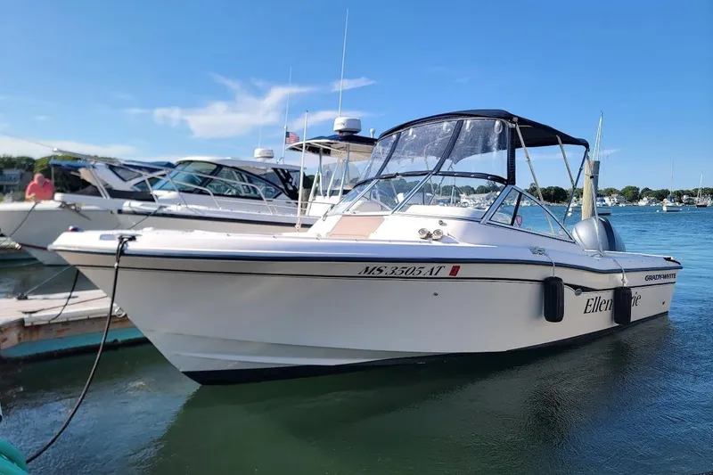 Slide: The Image of 2008 Grady-White Tournament 225 boat docked in a sunny marina setting. - 12