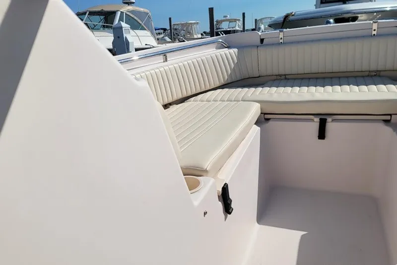 Slide: The Image of 2008 Grady-White Tournament 225 boat interior with white cushioned seating. - 8