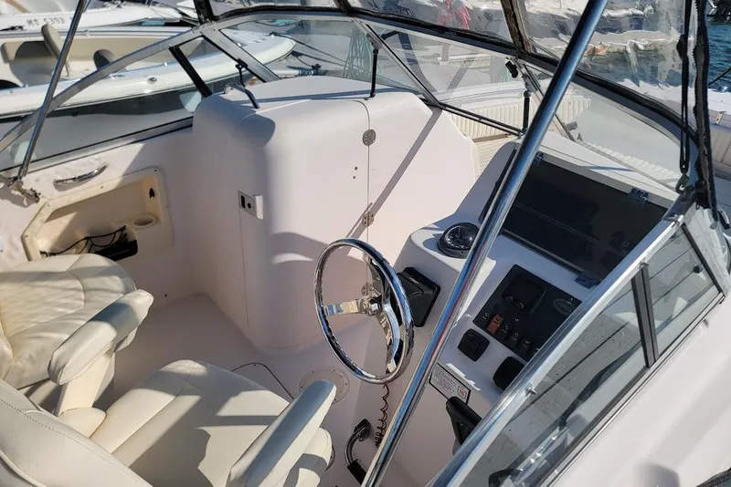 Slide: The Image of 2008 Grady-White Tournament 225 boat cockpit with steering wheel and control panel. - 14