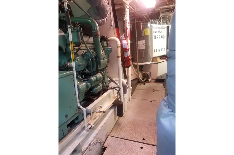 Slide: The Image of Engine room of a 1974 Custom Steel Cannery Tender with machinery and control panels. - 19