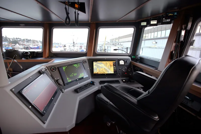 Slide: The Image of Interior of 1974 Custom Steel Cannery Tender with modern navigation equipment and captain's chair. - 2