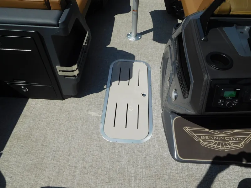 Slide: The Image of The image shows the floor of a Bennington 23 MSB boat with a recessed storage compartment. - 24