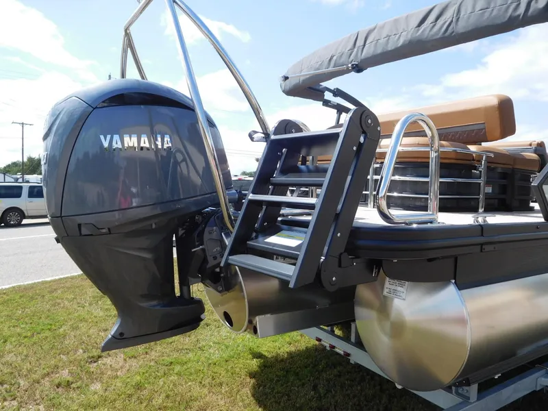 Slide: The Image of A Bennington 23 MSB pontoon boat with a large outboard motor and ladder at the rear. - 5