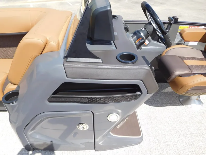 Slide: The Image of The image shows the helm of a 2026 Bennington 23 MSB with beige seating. - 19