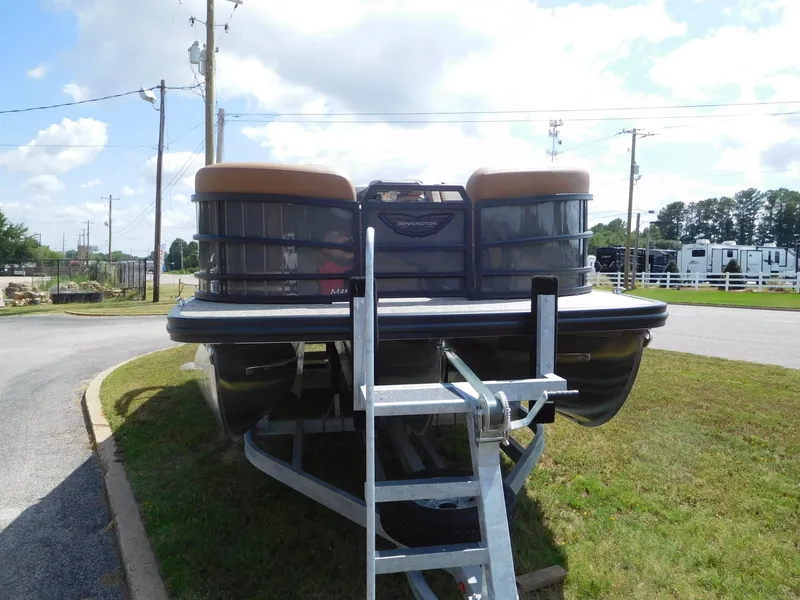 Slide: The Image of A 2026 Bennington 23 MSB pontoon boat is on a trailer in an outdoor setting. - 7