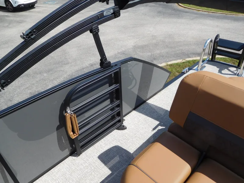 Slide: The Image of The image shows the deck of a Bennington 23 MSB boat with brown seats and a black railing. - 16
