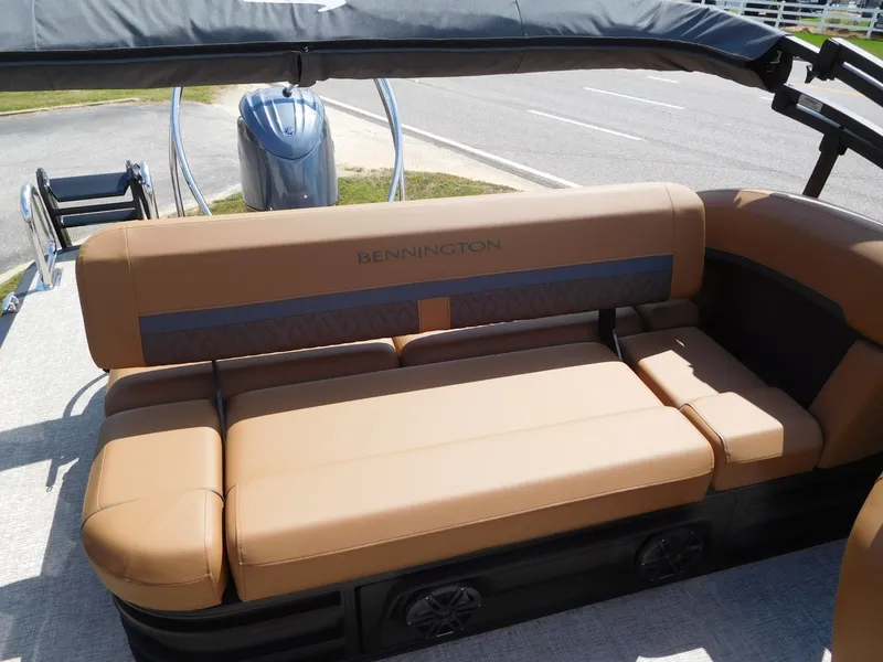 Slide: The Image of The image shows the seating area of a Bennington 23 MSB boat with brown upholstery. - 15