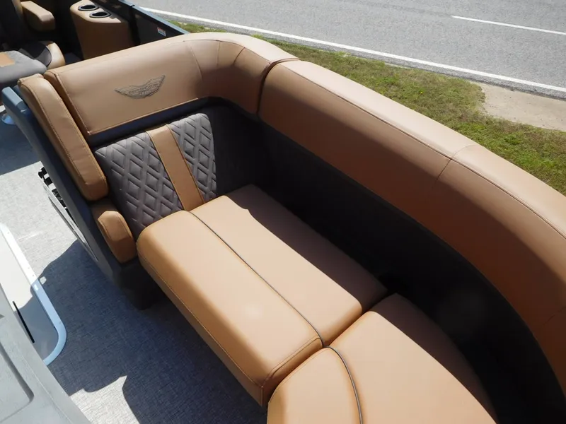 Slide: The Image of The 2026 Bennington 23 MSB features luxurious brown upholstery with quilted details and a sleek design. - 9