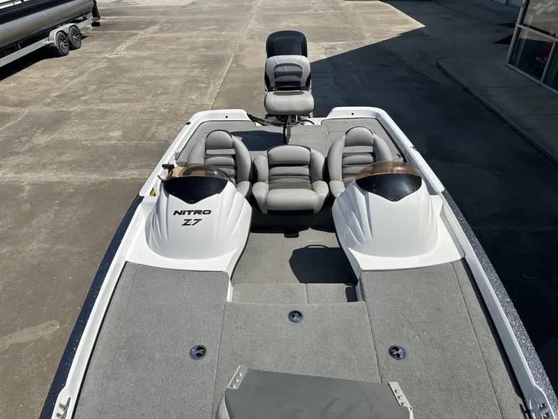 Slide: The Image of A 2008 Nitro Z-7 boat with gray cushioned seats and a spacious deck. - 7