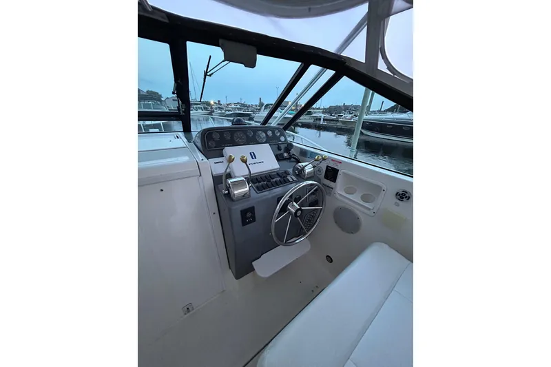 Slide: The Image of Cockpit of a 2004 Tiara 2900 boat, featuring steering wheel and control panel. - 10