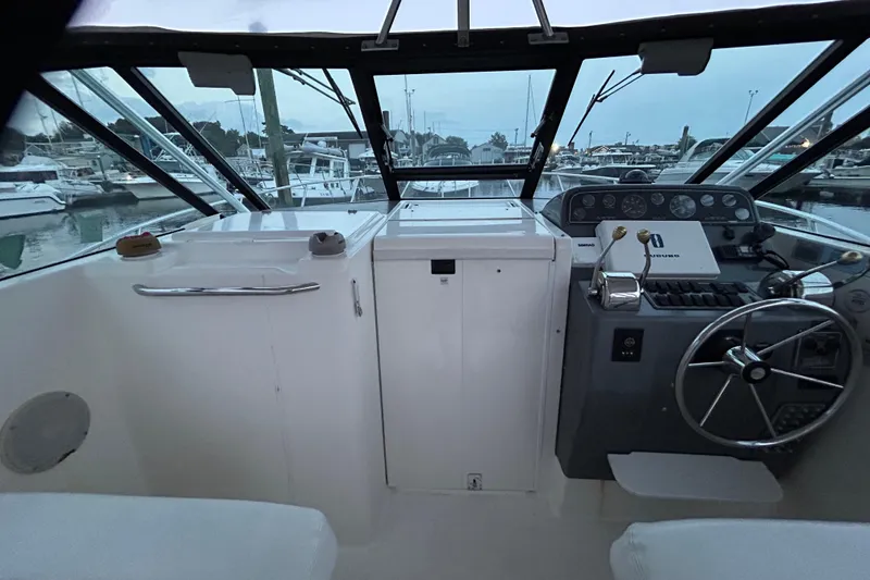 Slide: The Image of Cockpit view of a 2004 Tiara 2900 boat at a marina. - 18