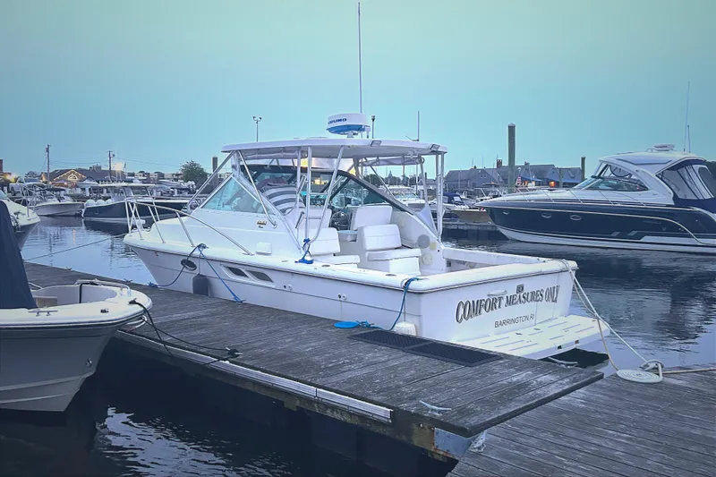 Slide: The Image of 2004 Tiara 2900 boat docked at a marina, featuring a sleek white design. - 22