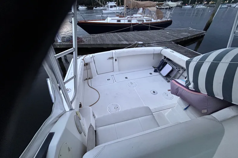 Slide: The Image of 2004 Tiara 2900 boat deck with seating, docked at marina. - 19