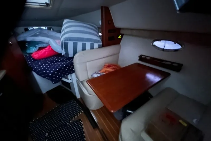Slide: The Image of Cozy interior of a 2004 Tiara 2900 boat with seating and bedding area. - 20