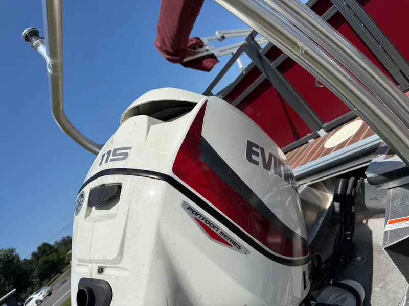 Slide: The Image of An Evinrude 115 outboard motor on a red Crest III 230 boat. - 13