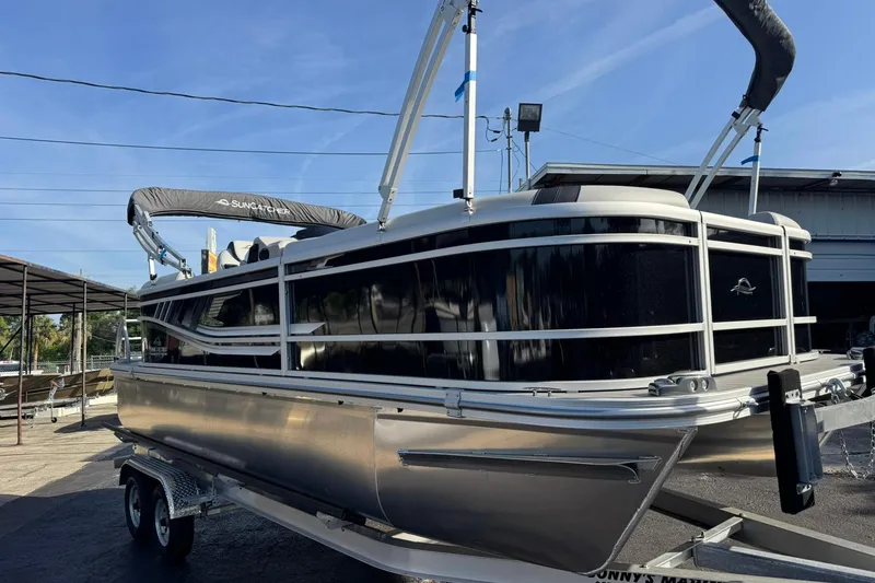 Slide: The Image of 2025 SunCatcher Select 20RC pontoon boat on trailer, outdoor display. - 15