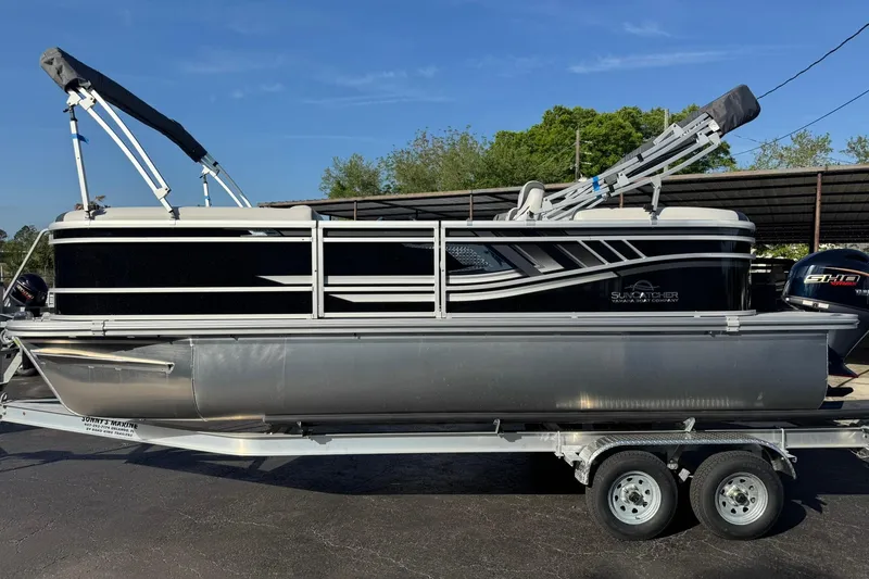 The Image of 2025 SunCatcher Select 20RC pontoon boat on trailer, side view, outdoors. - 0