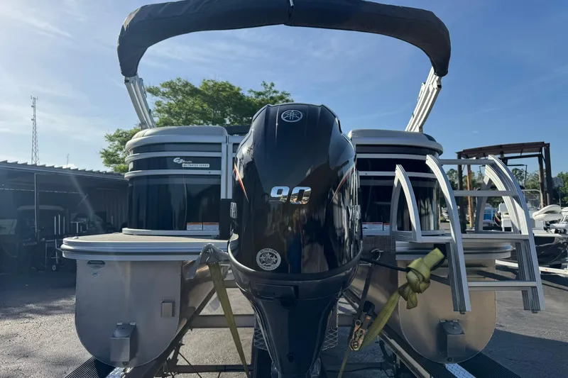 Slide: The Image of 2025 SunCatcher Select 20RC pontoon boat with Yamaha outboard motor, docked outdoors. - 8