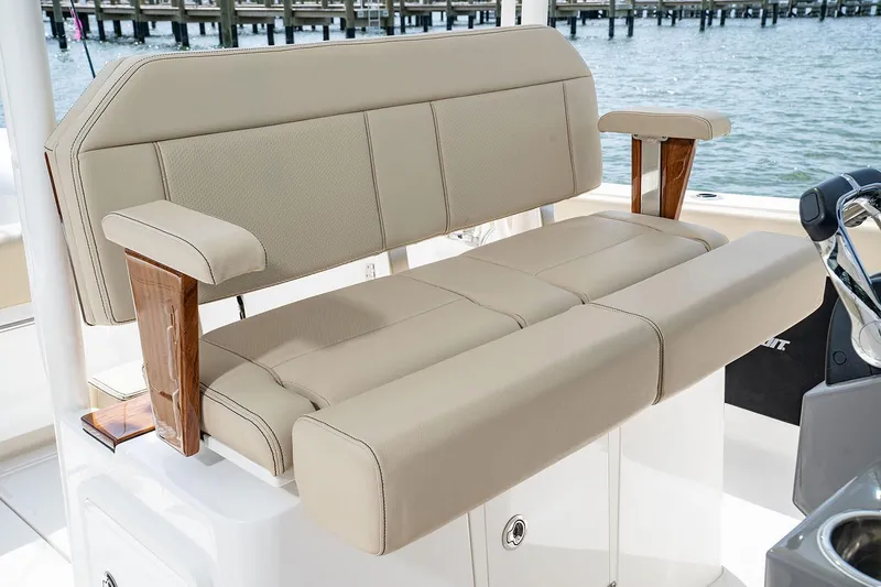 Slide: The Image of Manufacturer Provided Image: 2025 Pursuit S 288 Sport boat seating with beige upholstery and wooden armrests. - 15