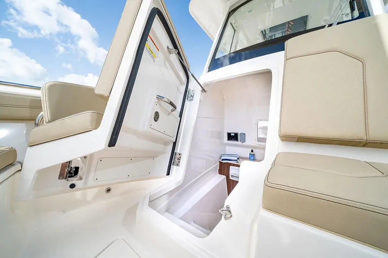 Slide: The Image of Manufacturer Provided Image: 2025 Pursuit S 288 Sport boat interior with open cabin door and seating. - 17