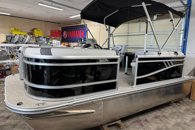 Slide: The Image of 2025 SunCatcher Select 16C pontoon boat displayed indoors with Yamaha accessories. - 4