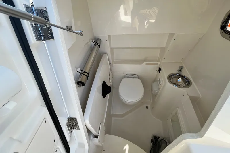 Slide: The Image of Interior of 2027 Pursuit S 268 Sport boat bathroom with toilet and sink. - 15