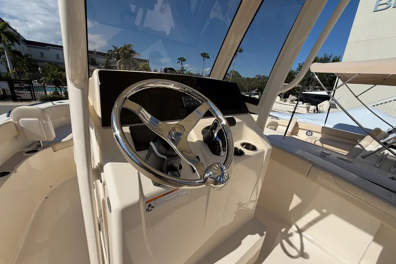 Slide: The Image of Steering console of 2027 Scout 220 XSF boat with modern controls and sleek design. - 20