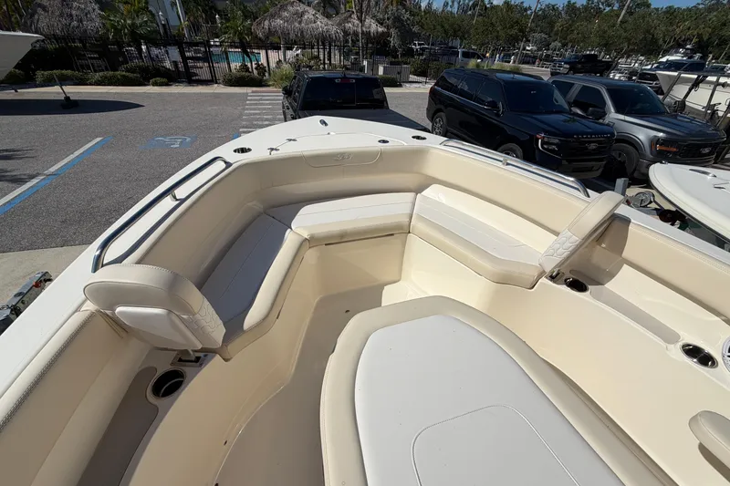 Slide: The Image of 2027 Scout 220 XSF boat interior with cushioned seating and cup holders. - 24