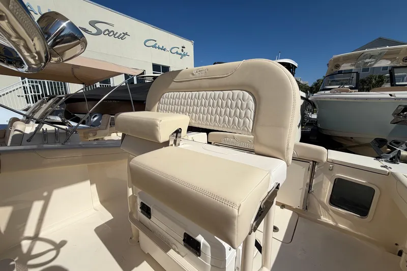 Slide: The Image of 2027 Scout 220 XSF boat interior with beige seating and modern design. - 16