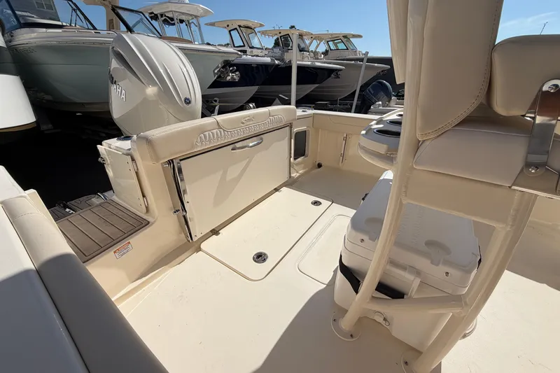 Slide: The Image of 2027 Scout 220 XSF boat interior with seating and Yamaha engine. - 7