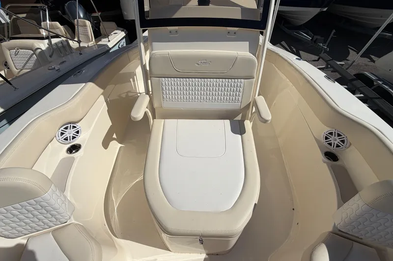 Slide: The Image of 2027 Scout 220 XSF boat interior with cushioned seating and built-in speakers. - 27