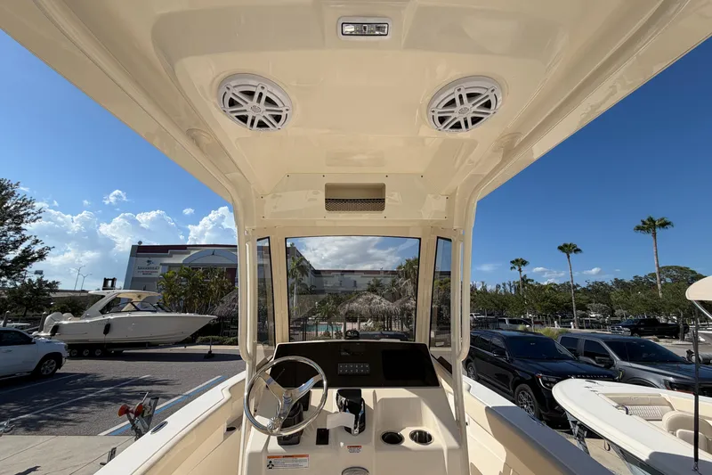Slide: The Image of Interior view of 2027 Scout 220 XSF boat cockpit with steering wheel and speakers. - 14