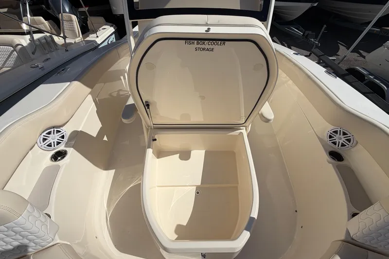 Slide: The Image of 2027 Scout 220 XSF boat with open fish box cooler storage in the deck. - 28