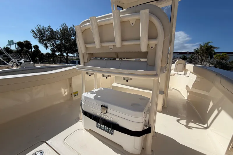 Slide: The Image of 2027 Scout 220 XSF boat interior with seating and cooler under sunny sky. - 11