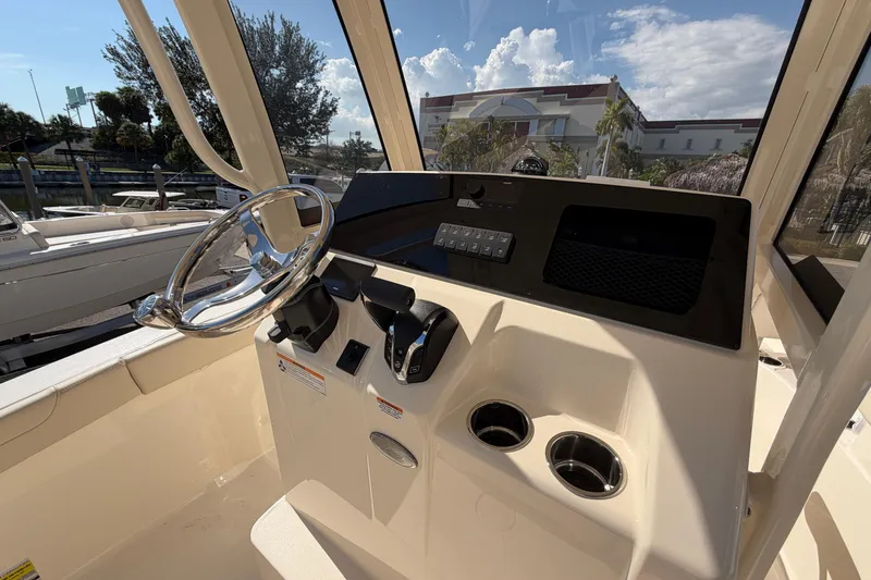 Slide: The Image of Steering console of 2027 Scout 220 XSF boat with modern controls and cup holders. - 18