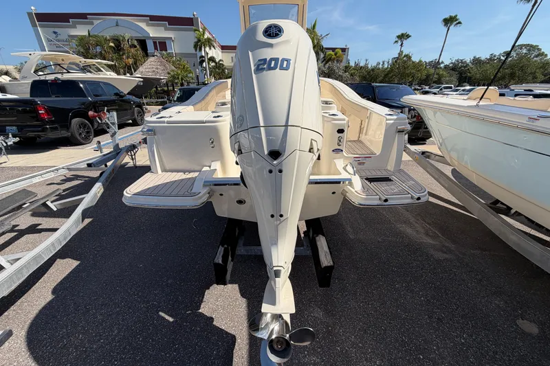 Slide: The Image of 2027 Scout 220 XSF boat with 200 HP engine displayed outdoors. - 4