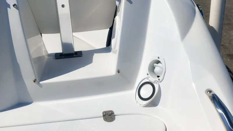 Slide: The Image of Close-up of a white deck on a Stingray 231 DC boat with speaker and seating area. - 5